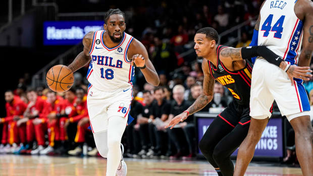 Philadelphia 76ers guard Shake Milton dribbles past Atlanta Hawks guard Dejounte Murray.